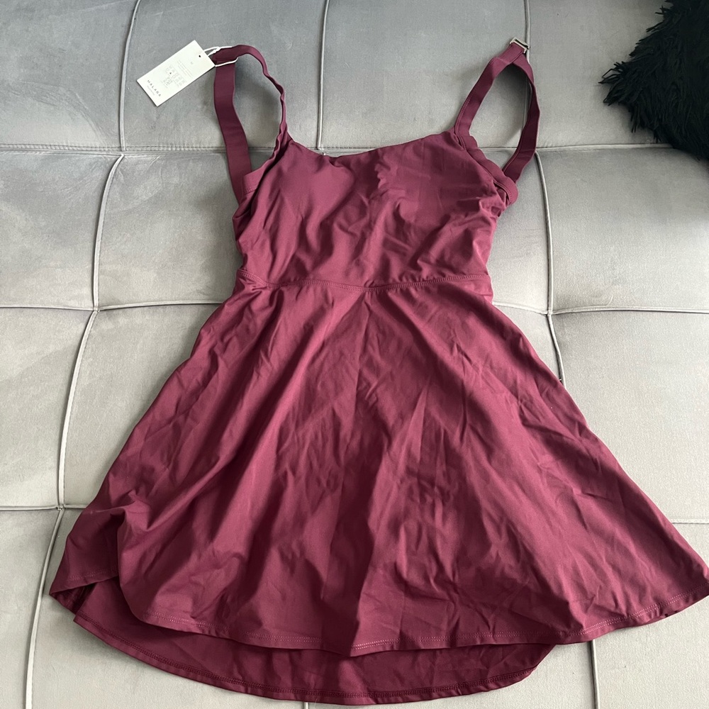 Backless athletic dress with attached shorts. Tags still on